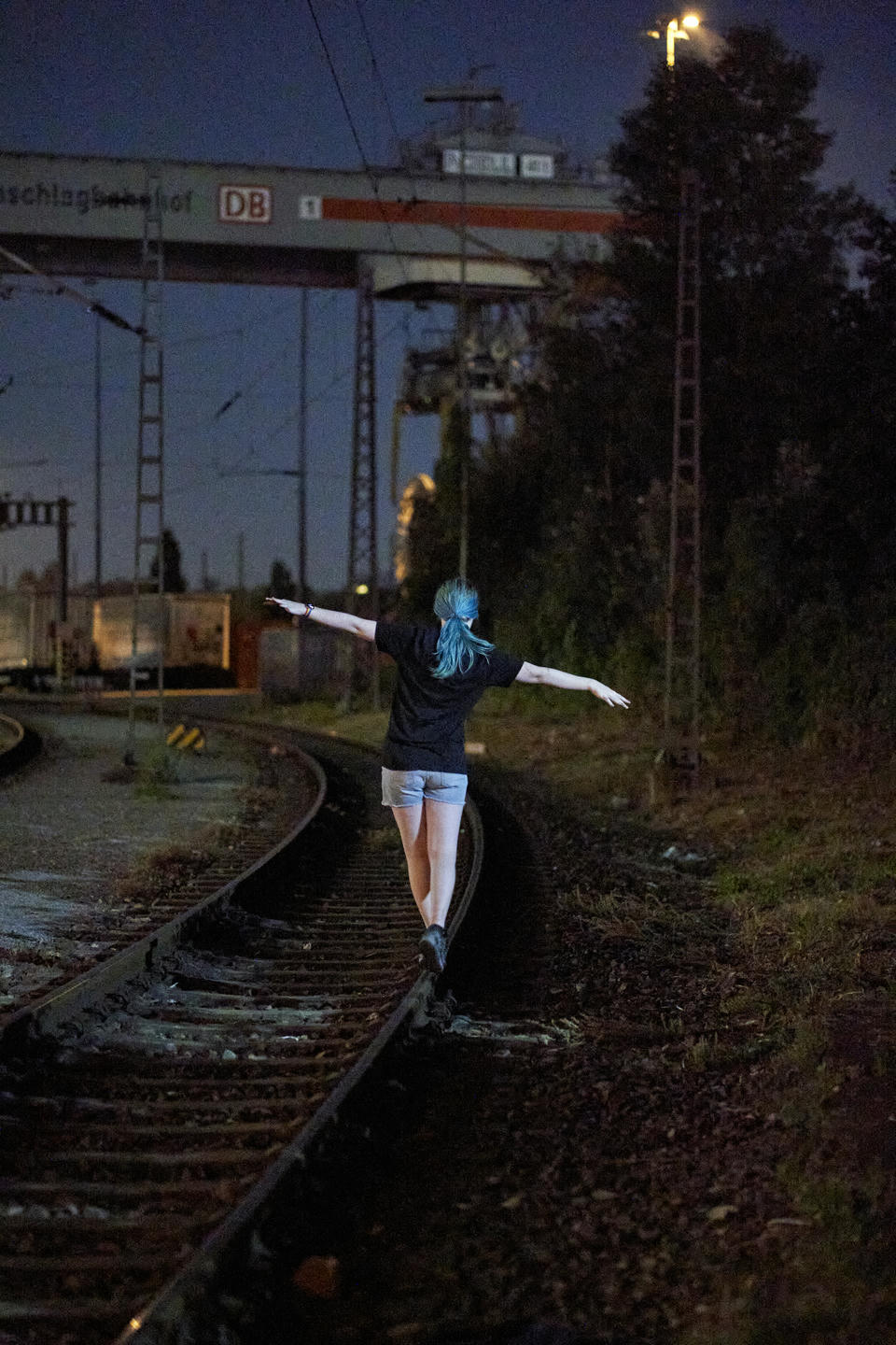 Me balancing on train tracks at night